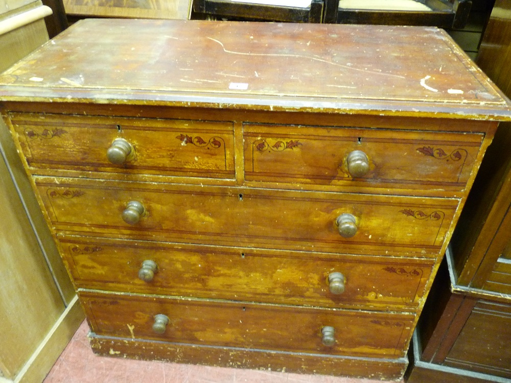 A STAINED PINE & FLORAL DECORATED CHEST of three long and two short drawers with turned wooden knobs