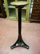 A REGENCY STYLE MAHOGANY TORCHERE, the tri-form base on turned bun feet and swept supports leading