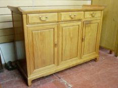 A CHINESE ROSEWOOD SIDEBOARD, the top with curved raised sides over two baize lined frieze drawers