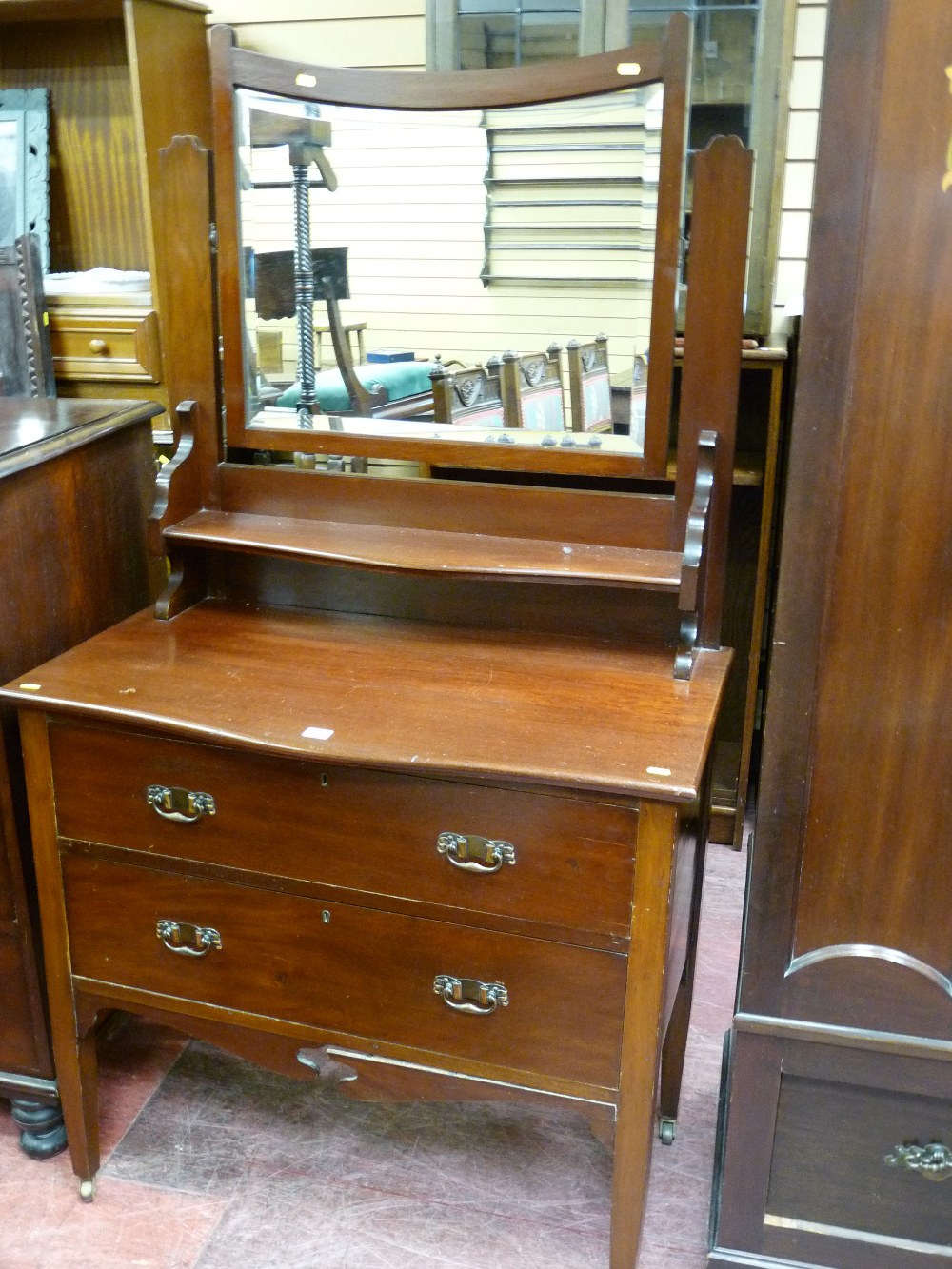 A PARTLY RE-FURBISHED EDWARDIAN MAHOGANY DRESSING TABLE having a one piece bevelled glass swing