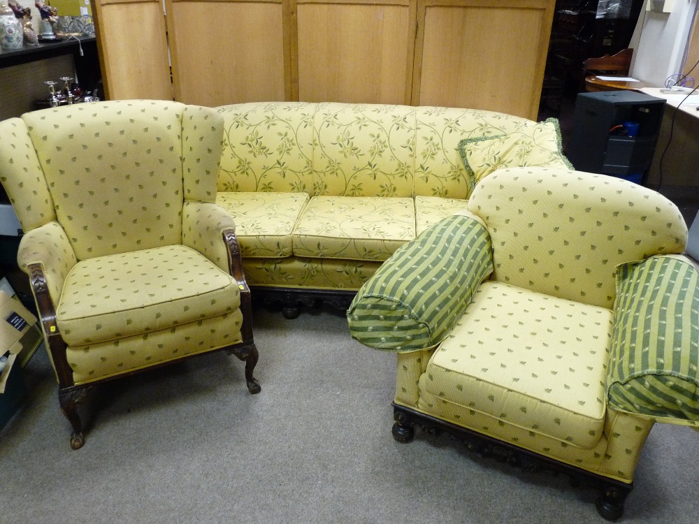 AN EARLY 20th CENTURY CARVED FRAMED THREE SEATER SETTEE with scrolled arms and matching armchair and