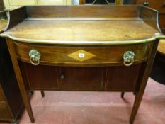 A MID 19th CENTURY COMPACT MAHOGANY SIDEBOARD having a railback and with a slightly bowed brass