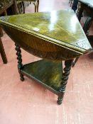 A TRIANGULAR OAK TWO TIER OCCASIONAL TABLE, the three top flaps opening to form a 57 cms diameter
