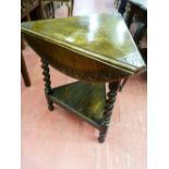 A TRIANGULAR OAK TWO TIER OCCASIONAL TABLE, the three top flaps opening to form a 57 cms diameter