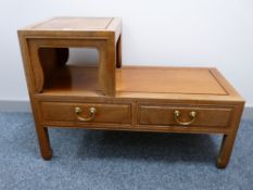 A CHINESE ROSEWOOD TELEPHONE SEAT, the near square raised section with shaped lower apertures, two