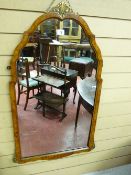 A REPRODUCTION WALNUT FRAMED WALL MIRROR, 91 cms high, 50 cms wide