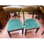 A PAIR OF REGENCY MAHOGANY SIDE CHAIRS, the wide concave top rail with carved apron decoration,