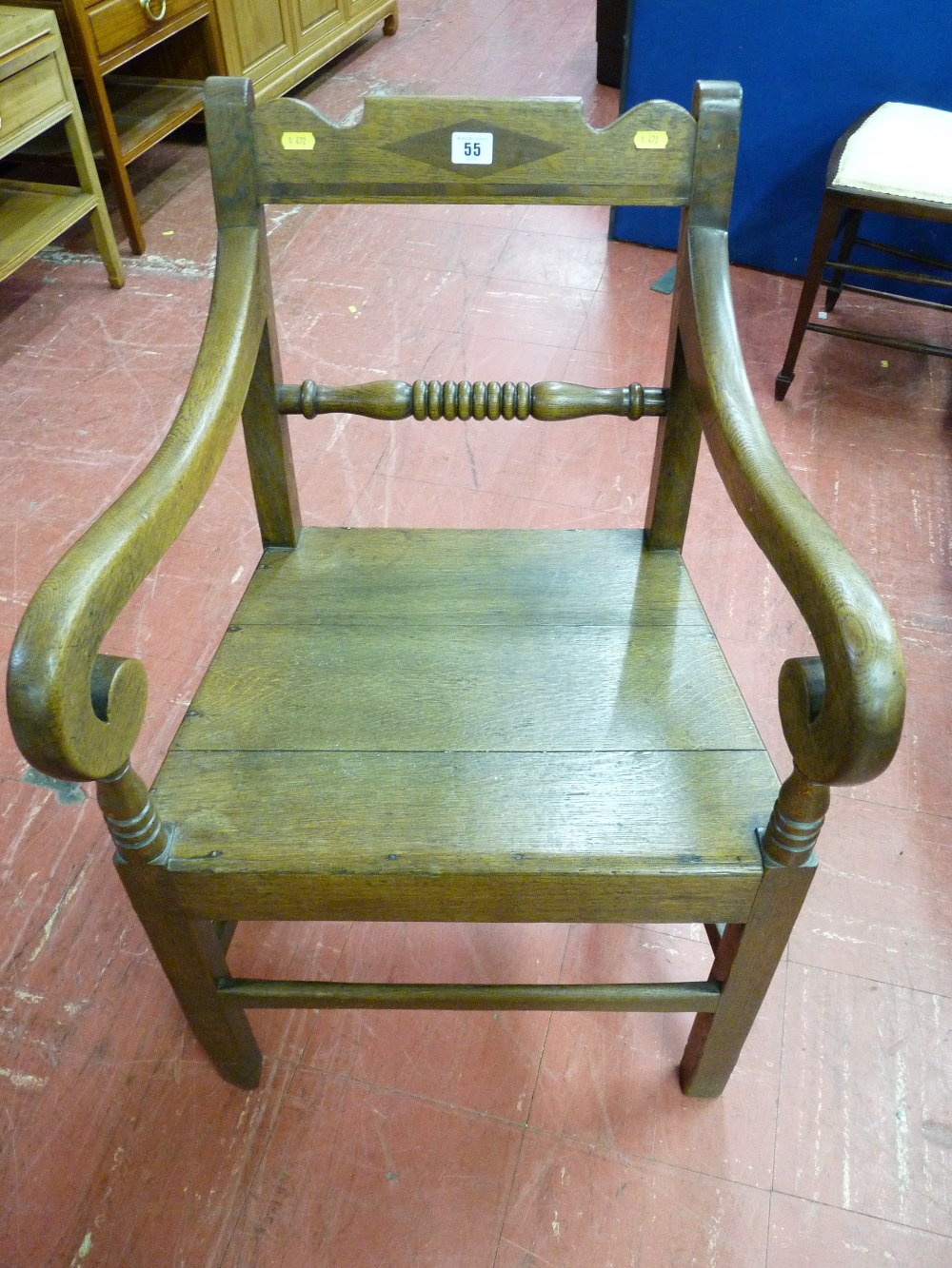 AN ANTIQUE OAK FARMHOUSE ARMCHAIR with diamond inlaid shaped top rail and bobbin turned centre