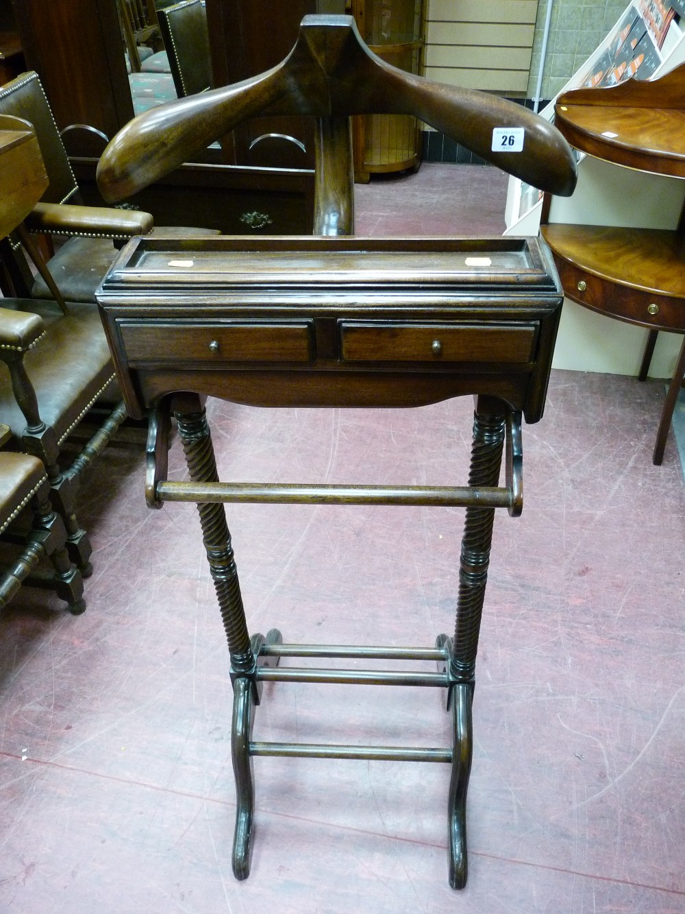 A REPRODUCTION HARDWOOD GENT'S VALET with coathanger, tray, two narrow drawers and rail on twist