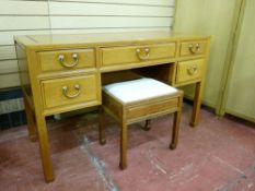 A CHINESE ROSEWOOD DESK WITH STOOL having a central frieze drawer with flanking twin drawers, all