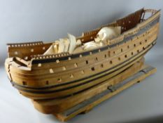 A 1930's ALL WOODEN OPEN HULL of a man at war ship, 112 cms long on a wooden stand