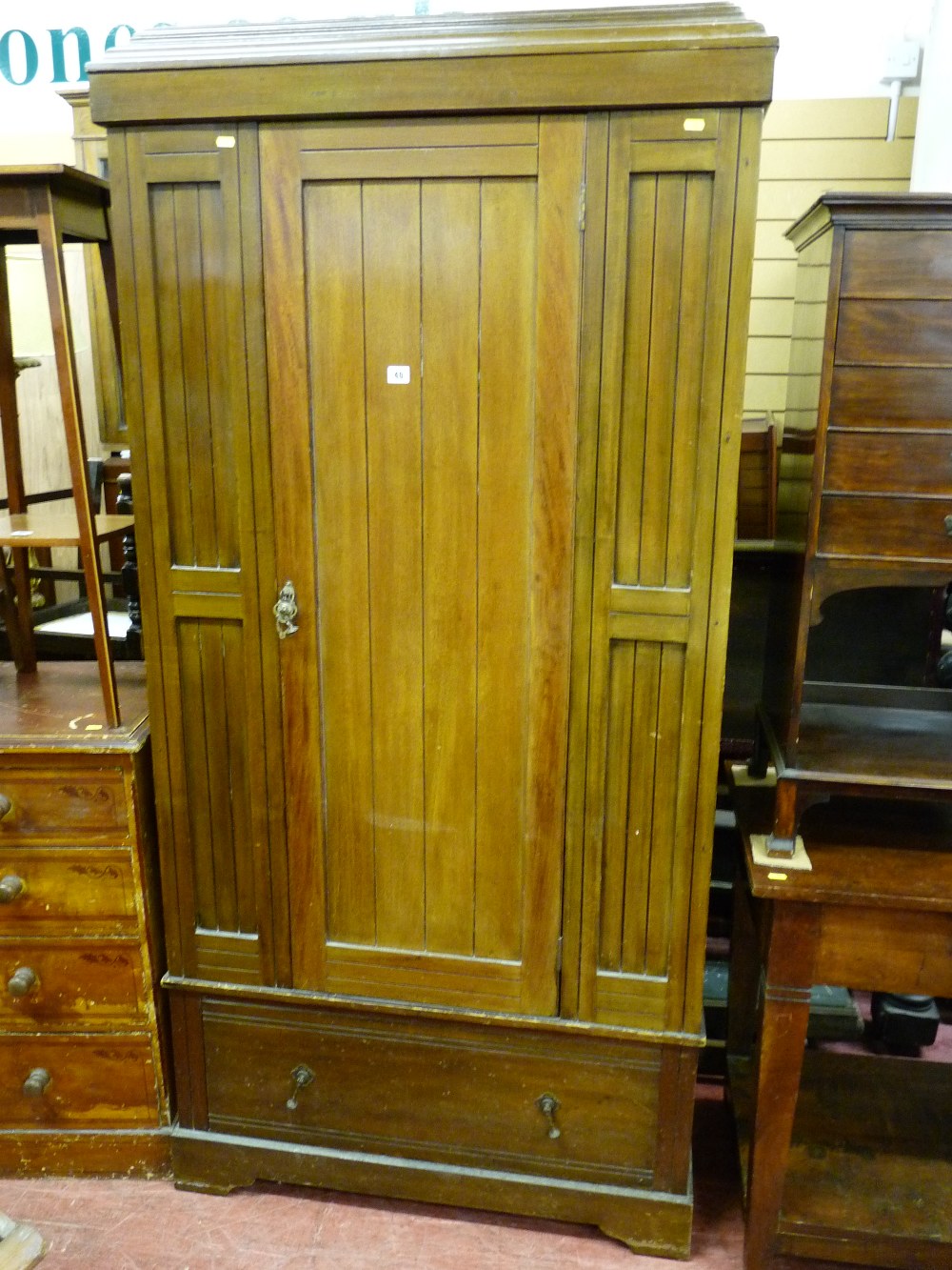 AN EDWARDIAN MAHOGANY SINGLE DOOR WARDROBE with base drawer