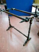 AN EARLY VICTORIAN TAPESTRY STRETCHER with hinged cylinder bearers, twist supports, turned wooden
