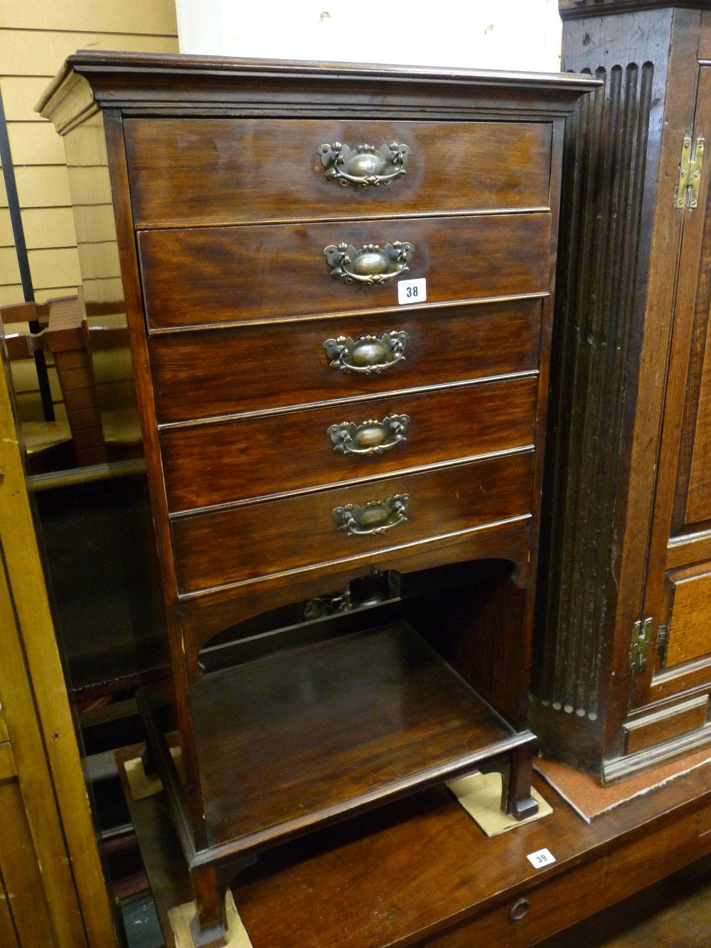 AN EDWARDIAN POLISHED MUSIC CABINET having five fall front drawers with copperized handles and a