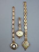 THREE NINE CARAT GOLD LADY'S WRISTWATCHES with expanding straps, one in half hunter style, 76 grms