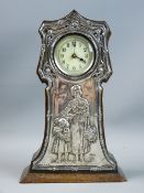 A SILVER FRONTED OAK MANTEL CLOCK, the shaped case housing an enamel dial with Arabic numerals,