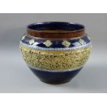 A DOULTON LAMBETH STONEWARE PLANTER having a raised central band of stylized floral on a cobalt
