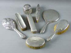 A PARCEL OF FIVE SILVER BACKED DRESSING TABLE BRUSHES, various shapes, two silver backed hand