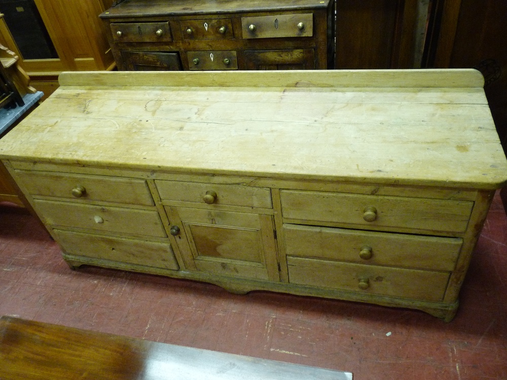 A GOOD ANTIQUE PINE DRESSER BASE, the railback two boarded top with rounded front corners, the lower