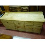 A GOOD ANTIQUE PINE DRESSER BASE, the railback two boarded top with rounded front corners, the lower