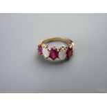 A FIFTEEN CARAT GOLD RUBY (three) & OPAL (two) DRESS RING, all oval cut stones, size 'O/P', 4.5