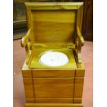 AN EDWARDIAN SATIN WALNUT BOX SEAT COMMODE, the moulded edge top lifting to reveal fold-out open