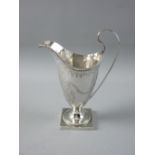 A SQUARE BASED HELMET SHAPED SILVER CREAM JUG with bright cut and beadwork decoration, 4 troy ozs,