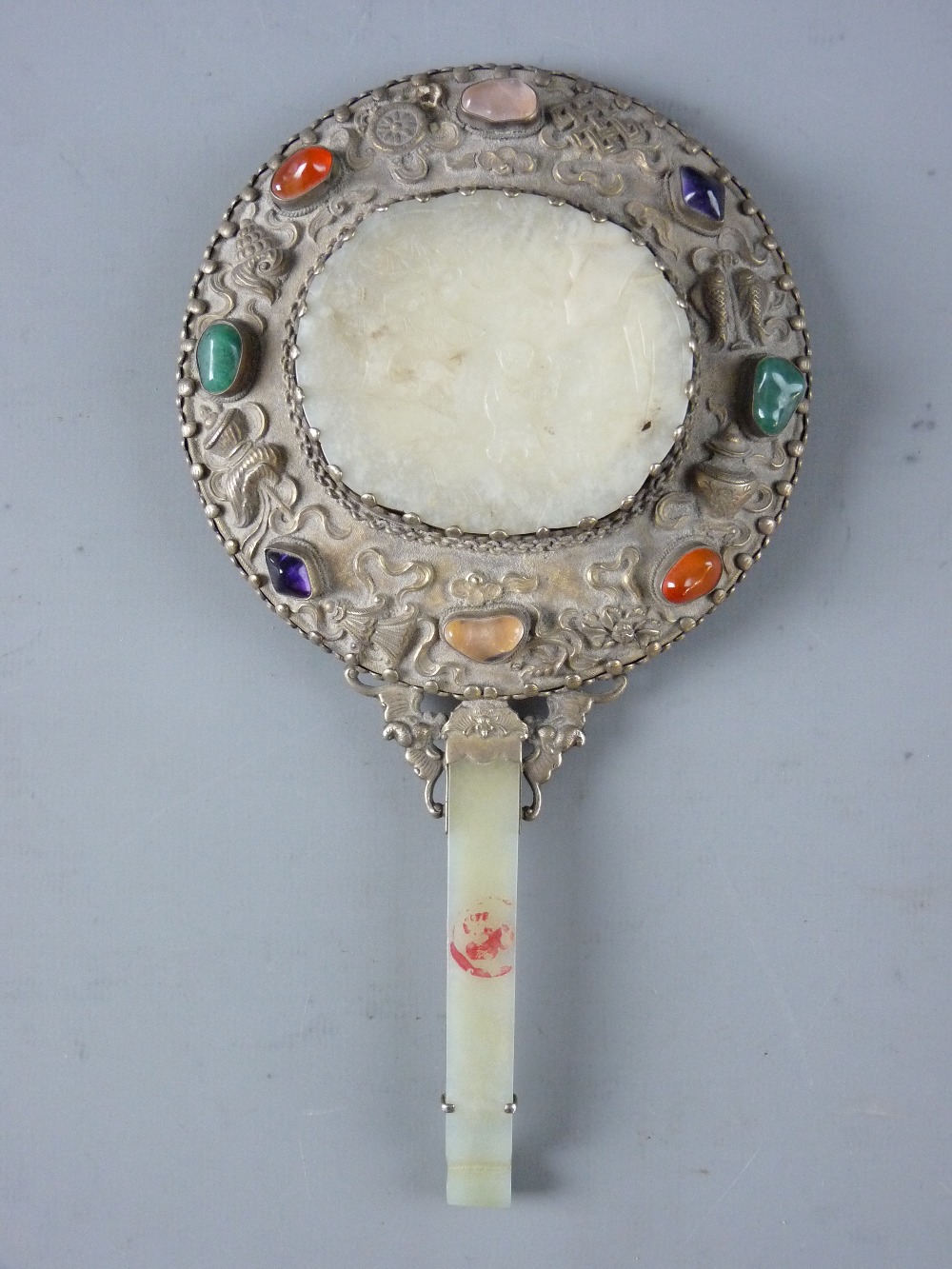 A CHINESE SILVER & JADE CIRCULAR HAND MIRROR with celadon jade handle having a bat terminal and