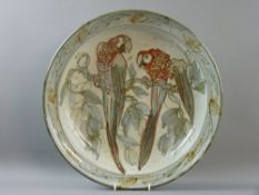 AN ENGLISH STUDIO POTTERY DISHED CIRCULAR CHARGER depicting two perched parrots, 42 cms diameter