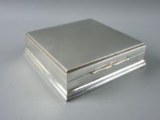 A 925 STERLING SILVER SQUARE TRINKET BOX having an attractive burr walnut lined interior, 13 cms