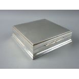 A 925 STERLING SILVER SQUARE TRINKET BOX having an attractive burr walnut lined interior, 13 cms