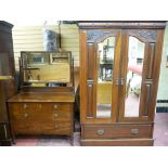 AN EDWARDIAN CARVED MAHOGANY WARDROBE & NON-MATCHING DRESSING TABLE having carved top panel doors