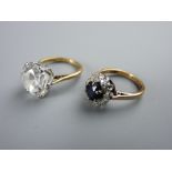 TWO NINE CARAT GOLD DRESS RINGS including a diamond set with central blue sapphire, size 'J' and a