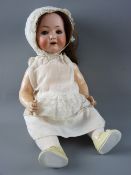 AN ANTIQUE BISQUE HEADED DOLL with composition body and limbs having sleepy blue eyes with lashes