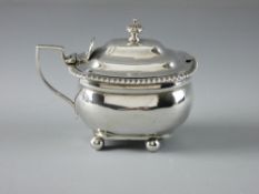 AN OBLONG SILVER MUSTARD POT, no liner, with hinged lid and on four ball feet, 5 troy ozs, London