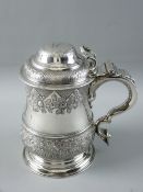 A FINE GEORGE III SILVER TANKARD having a partially decorated body of raised flowers and fish
