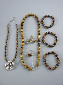 A GOOD ENSEMBLE OF TIGER'S EYE ADORNED DRESS JEWELLERY - a bead necklace, three bracelets, a