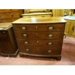 A REGENCY INLAID MAHOGANY BOW FRONT CHEST of four long drawers with oval backplates and swing