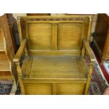 A NEAT OAK MONK'S BENCH with turned arm supports and box seat base, 72 cms high, 81.5 cms wide, 48.5