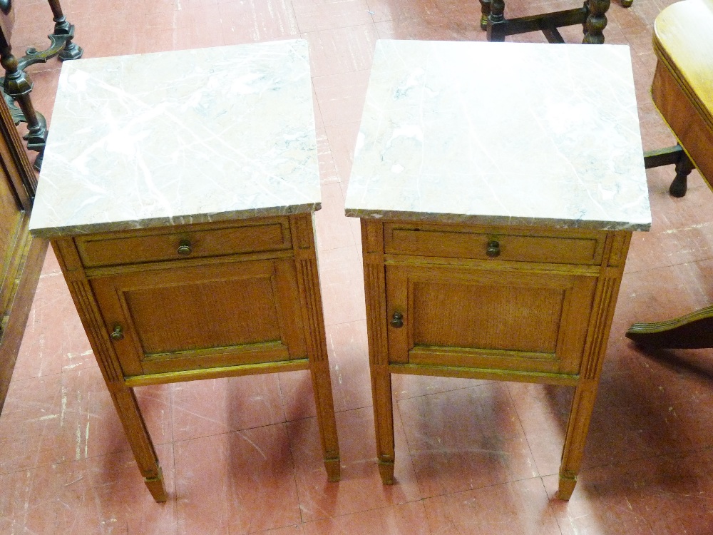 A PAIR OF CONTINENTAL OAK MARBLE TOPPED BEDSIDE CABINETS, the pink marble near square tops over a