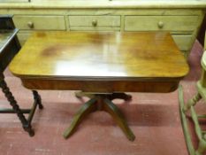 A REGENCY MAHOGANY FOLDOVER TEA TABLE having a polished top and interior, central panel lower