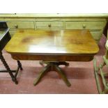 A REGENCY MAHOGANY FOLDOVER TEA TABLE having a polished top and interior, central panel lower