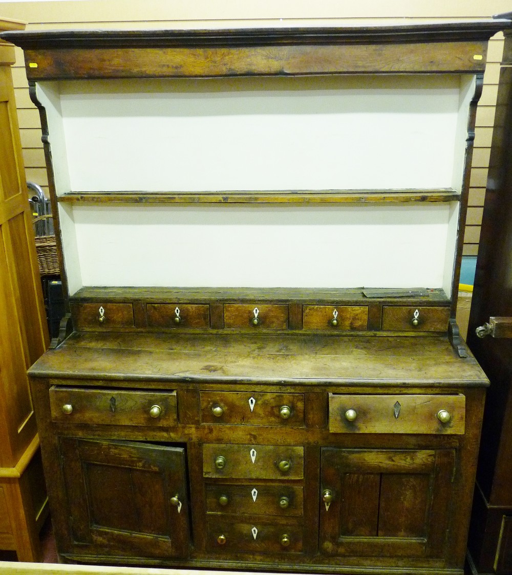 AN 18th CENTURY NORTH WALES OAK DRESSER with spice drawers, the two shelf rack with inverted cornice