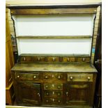 AN 18th CENTURY NORTH WALES OAK DRESSER with spice drawers, the two shelf rack with inverted cornice