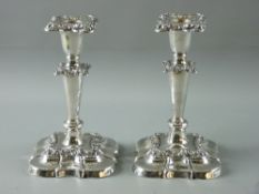 A PAIR OF EDWARDIAN HALLMARKED SILVER CANDLESTICKS with embossed floral decoration and detachable