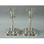 A PAIR OF EDWARDIAN HALLMARKED SILVER CANDLESTICKS with embossed floral decoration and detachable