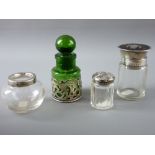 FOUR HALLMARKED SILVER & GLASS DRESSING TABLE CONTAINERS to include a green glass smelling salts