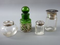 FOUR HALLMARKED SILVER & GLASS DRESSING TABLE CONTAINERS to include a green glass smelling salts