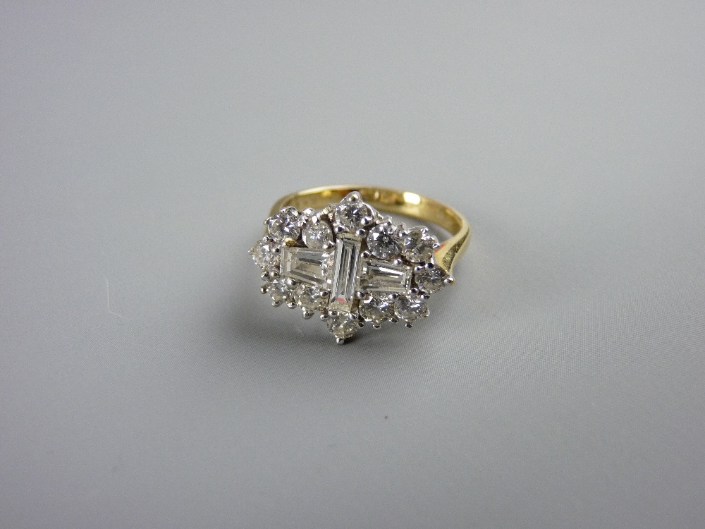 AN EIGHTEEN CARAT GOLD DIAMOND DRESS RING having a centre single baguette cut diamond with a