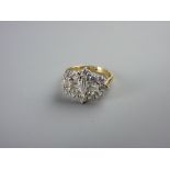 AN EIGHTEEN CARAT GOLD DIAMOND DRESS RING having a centre single baguette cut diamond with a